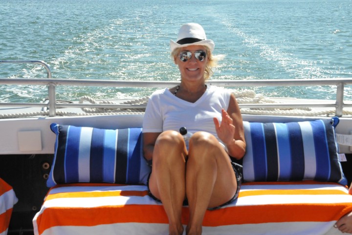 woman smiling on back of boat