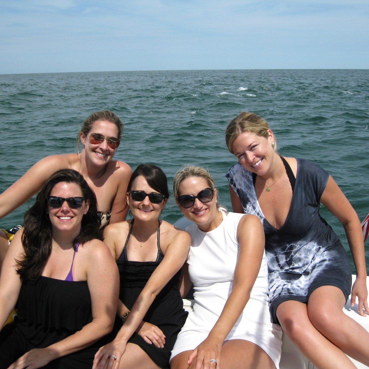 group of women posing on boat