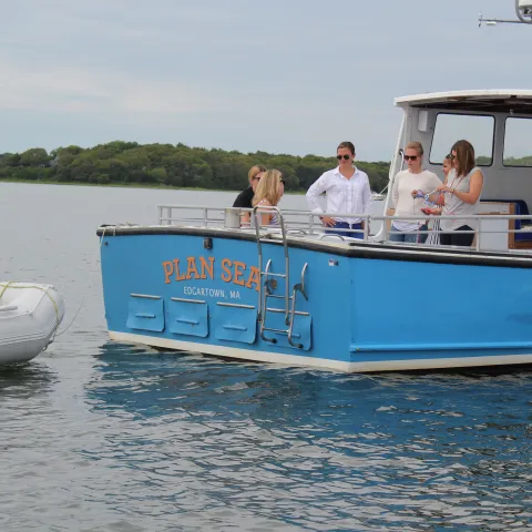 group hanging out on back of boat