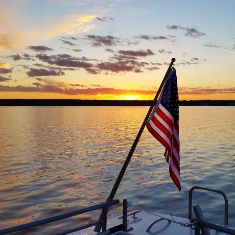 sunset with american flag in foreground
