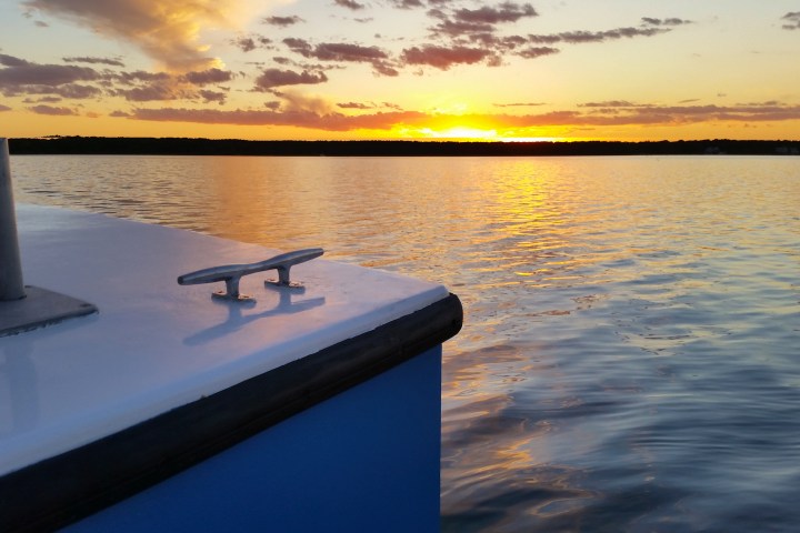 sunset with corner of boat in view