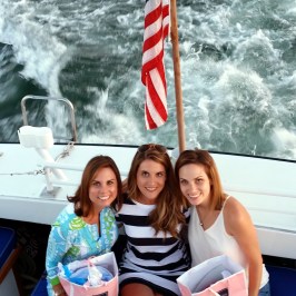 girls posing on back of boat