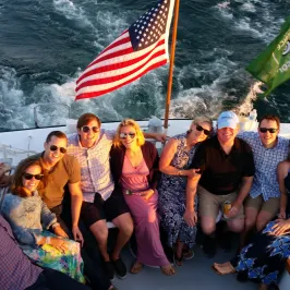 group smiling on back of boat