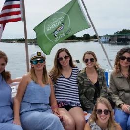 group of girls posing on the back of the boat