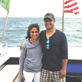 boy and girl posing for picture on boat