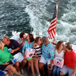 couples kissing on back of boat