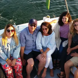 group smiling on back of boat