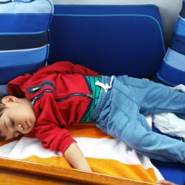 little boy sleeping on boat