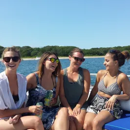four girls laughing on the boat
