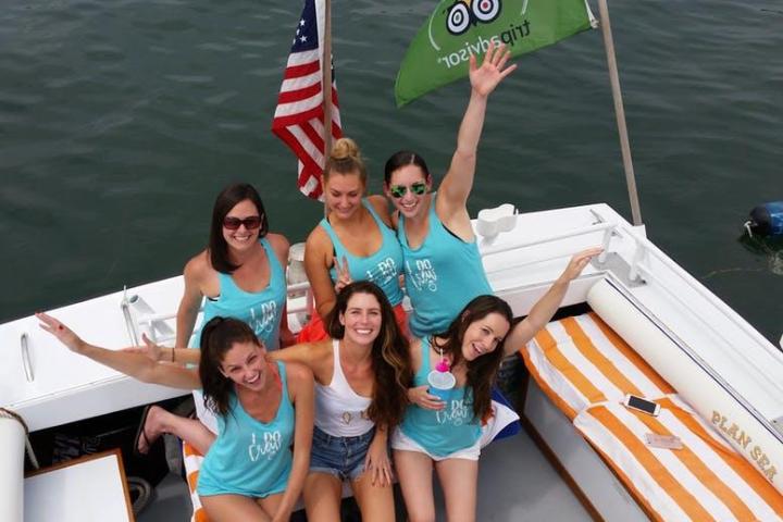 a group of people on a boat posing for the camera