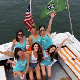 a group of people on a boat posing for the camera
